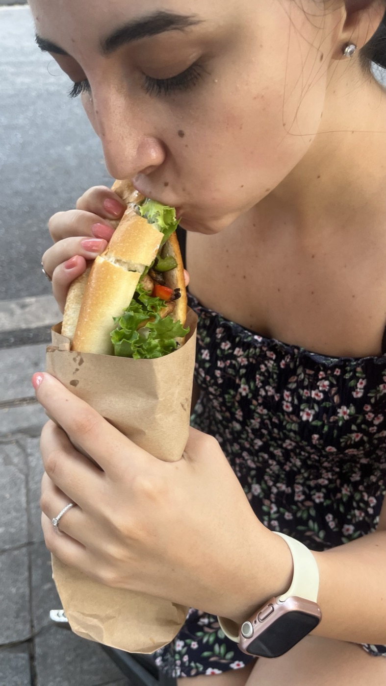 Customer enjoying a banh mi sandwich
