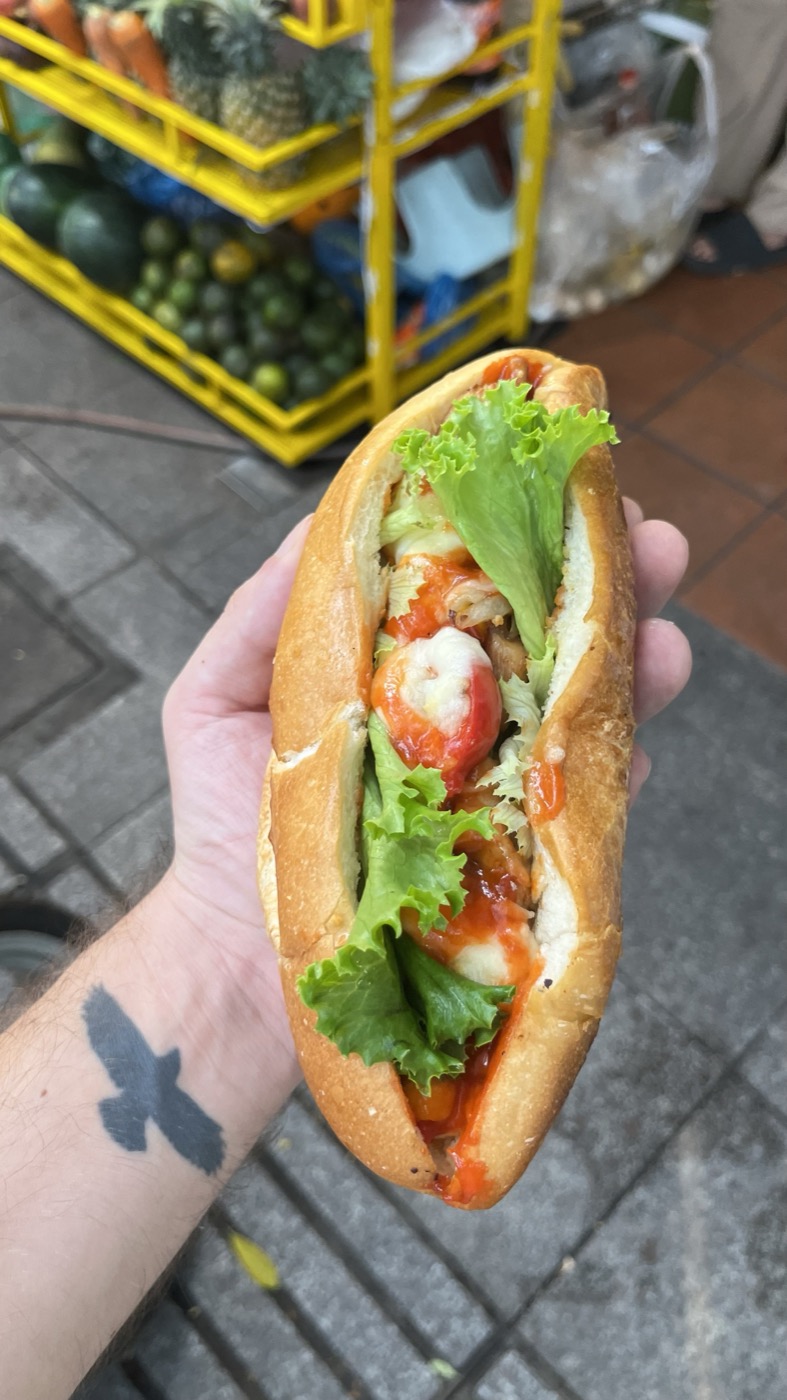 Fresh banh mi sandwich held outside the pop-up